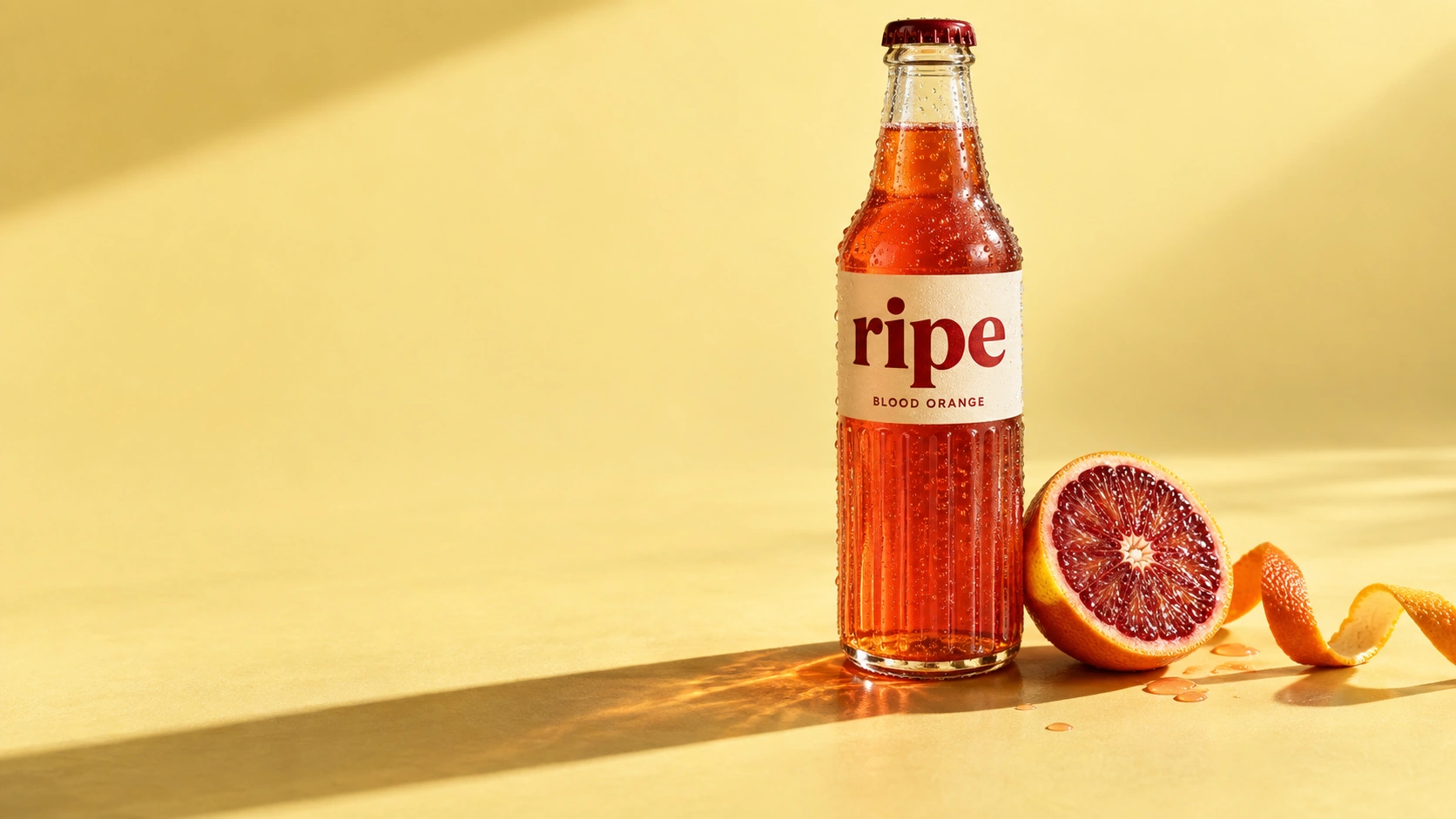 RIPE blood-orange soda in fluted glass with warm sunlight and fresh citrus