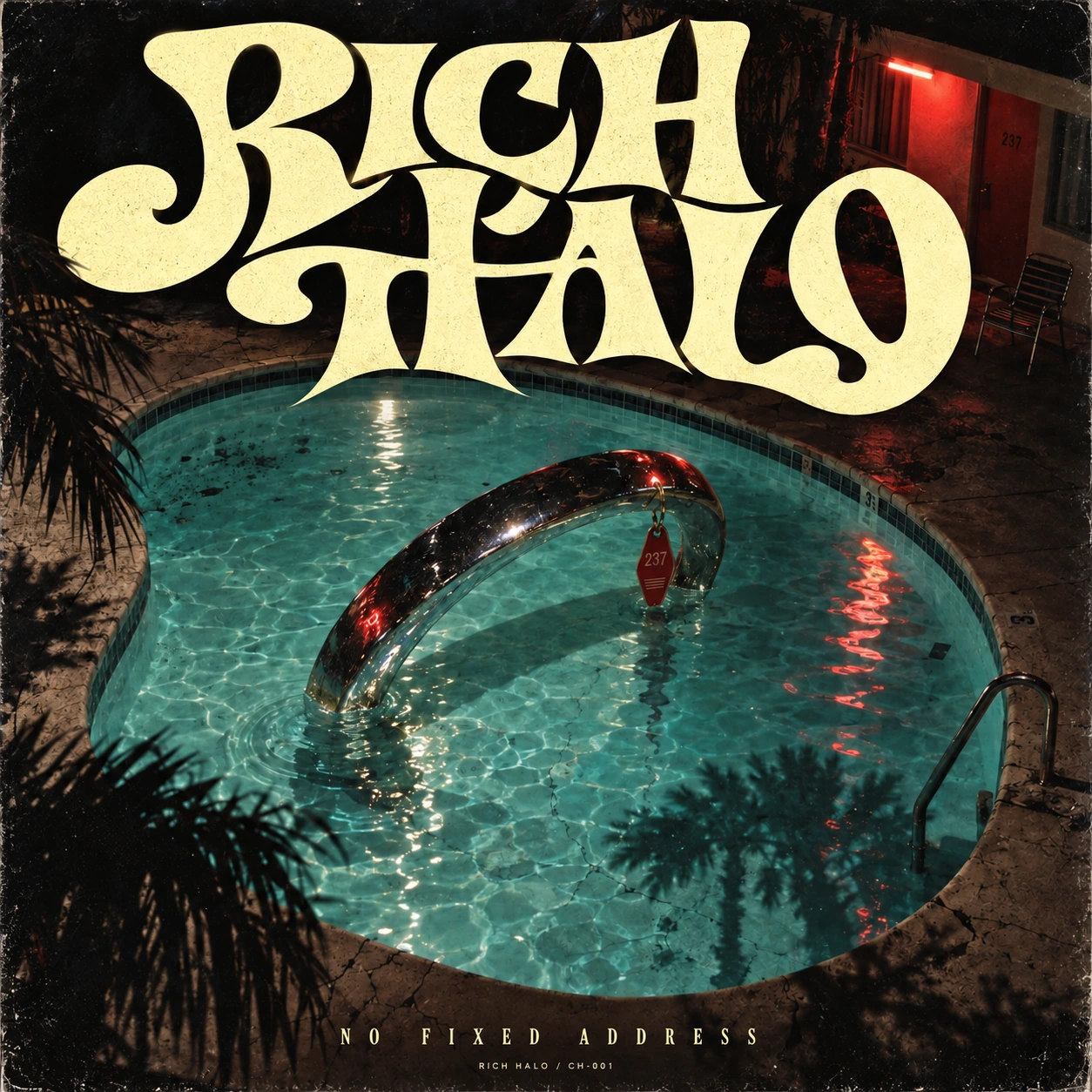 Original indie-rock album photograph: a chrome halo reflected in a motel swimming pool at night